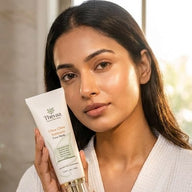 Woman holding Thévaa Ultra Glow Turmeric Face Mask